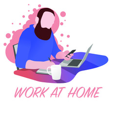 Work at home. Home Office. A man sits on a chair, at a table, has a telephone in one hand and works on a laptop from home. On the table is a cup of tea. Self-isolation. Quarantine.