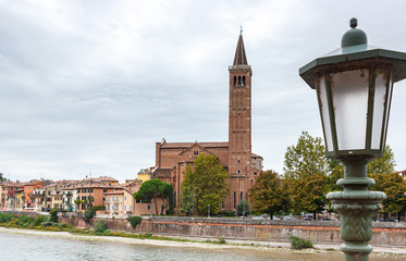 Obraz premium View of the Adige river, embankment and the Church of St. Anastasia in old part of Verona city in Italy