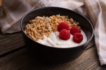  delicious breakfast with yogurt, granola and raspberries