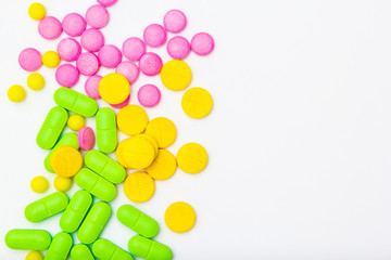 ndful of tablets and pills in hand isolated on white