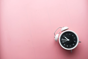 high angle view of alarm clock on pink.
