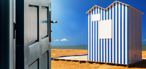Opened door concept with a beach cabin typical of Normandy beaches on background