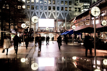 Silhouetted business people in London's Canary Wharf financial district- UK