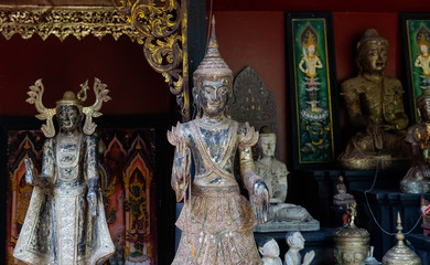 .Buddhist and Hindu statues of deities in ritual rites and traditions