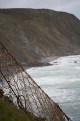 line of net next to the cliff of the beach
