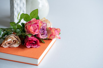 Artificial antique roses on kitchen table.
Quiet and cozy kitchen concept.