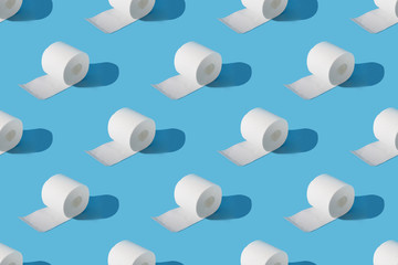 Seamless pattern of rolls of soft toilet paper on blue. Isometric. Increased potential. High...