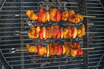 Grilled delicious shashlik with tomato and onion in outdoor at home balcony, summer time