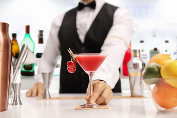 Bartender serving an alcoholic cocktail drink