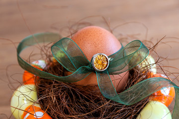 Easter egg richly decorated with a gem and organza ribbons. Unusual gift for Easter.
