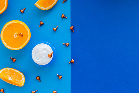 Vitamin C, natural anti aging cosmetics cream bottle and serum ampula with citrus.Womens skincare cosmetics product with vitamins.Face skin revitalizing, healing capsules with natural oil.