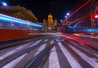 Fototapeta na wymiar Saint Mark's church at night and light trails from passing trams and buses