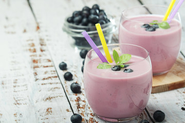 Two glasses with blueberry yogurt	