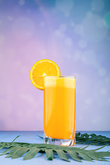Freshly squeezed orange juice isolated on blue backdrop