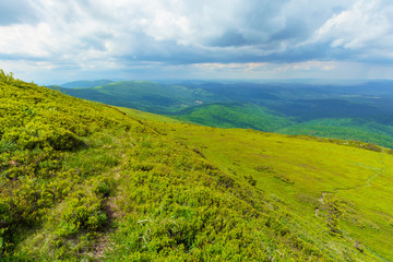 path through mountain range. beautiful alpine meadows of carpathian landscape on a cloudy day in summer. dividing watershed ridge