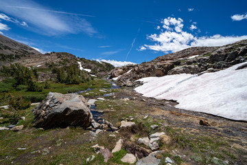 Patch of remaining snow along the 20 Lakes Basin hiking trail in Eastern Sierra Nevada Mountains of California on a sunny summer day