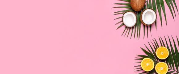 Summer tropical composition. Green tropical leaves of palm trees and monstera, coconut, orange on...