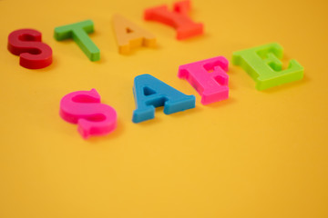 Words spelling stay safe against yellow background