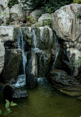 Fototapeta na wymiar small waterfall with rocks and moss, china