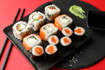 Delicious sushi rolls on red background. Japanese food
