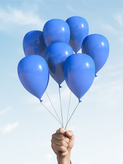 A few blue balloons in the hand