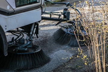 A cleaning machine is cleaning the asphalt.