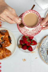 Unrecognizable woman having breakfast in pajamas at home in quarantine