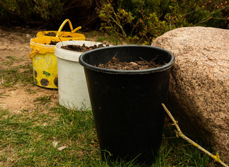 Garden job with different buckets with ground inside