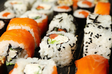 Delicious sushi rolls on wooden background, close up Japanese food