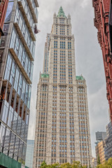 Fototapeta na wymiar The Woolworth Building 1913 neo-Gothic skyscraper a famous architectural landmark during the gloomy weather shot from Park Row street, New York.