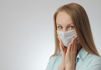 woman with medical mask. portrait of blonde girl. anxiety, excitement and fear of contracting a virus concept