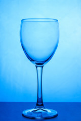 Glass of white wine close-up on a blue background