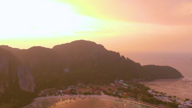 Panorama of Phi Phi island, Krabi province, Thailand. Spectacular color sunset over the sea and islands. Amazing twilight in the tropics and calm Indian Ocean. Aerial 4k view