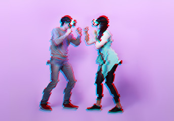 Fototapeta na wymiar Couple with virtual reality headset are playing game and fighting. Image with glitch effect.