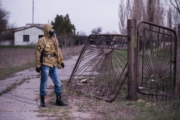 Lonely postapocalyptical warrior standing by the broken gate