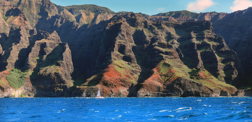 Sailboat Cruise in Blue Pacific Ocean near Napali Coast Cliffs in Kauai Hawaii
