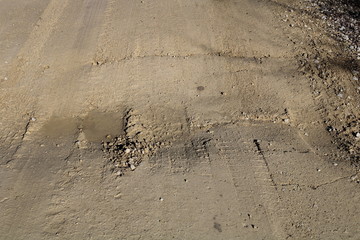 Gravel road, frost heave and dip at center line culvert
