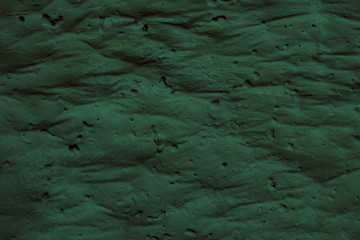 The texture of the uneven wavy turquoise surface. Bumpy turquoise background