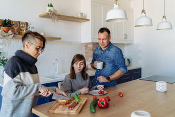 Family sitting at the kitchen and preparing food