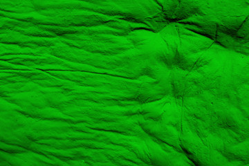 Texture of bright green chewed chewing gum. Background from bright green chewing gum