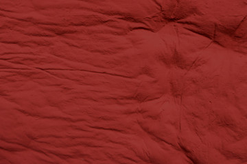 The texture of red chewed chewing gum. Red chewing gum background