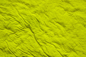 Texture of crumpled yellow fabric. Yellow pleated fabric. Crumpled yellow surface background