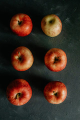 
Red apples on black background.