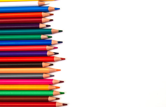 Multicolored wooden pencils on the right with an empty space for text, copy space, flat lay, on a white isolated background