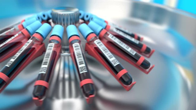 Blood samples in test tubes rotates in a centrifuge to separate blood from plasma for further analysis. Scientists biochemical laboratory manufacturing a vaccine against the covid-19 coronavirus.