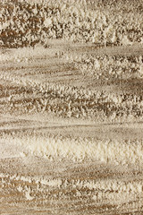 Blurry image of white flour on wooden background.  Abstract food backdrop. White powder texture background.