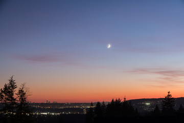 Crescent Moon Hanging Over A Sunset