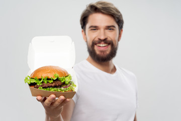 young man eating hamburger