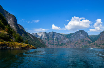 Fototapeta na wymiar Beautiful view on summer sunny day on Sognefjord or Sognefjorden (the King of the Fjords), the largest and deepest fjord in Norway, Scandinavia. Tourism vacation and travel.
