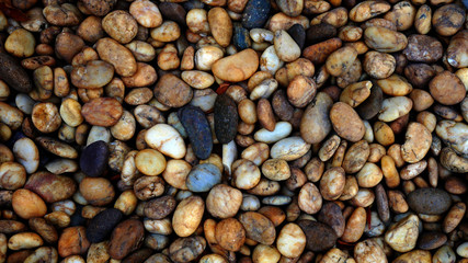 brown small stone background. pebble beach stone garden